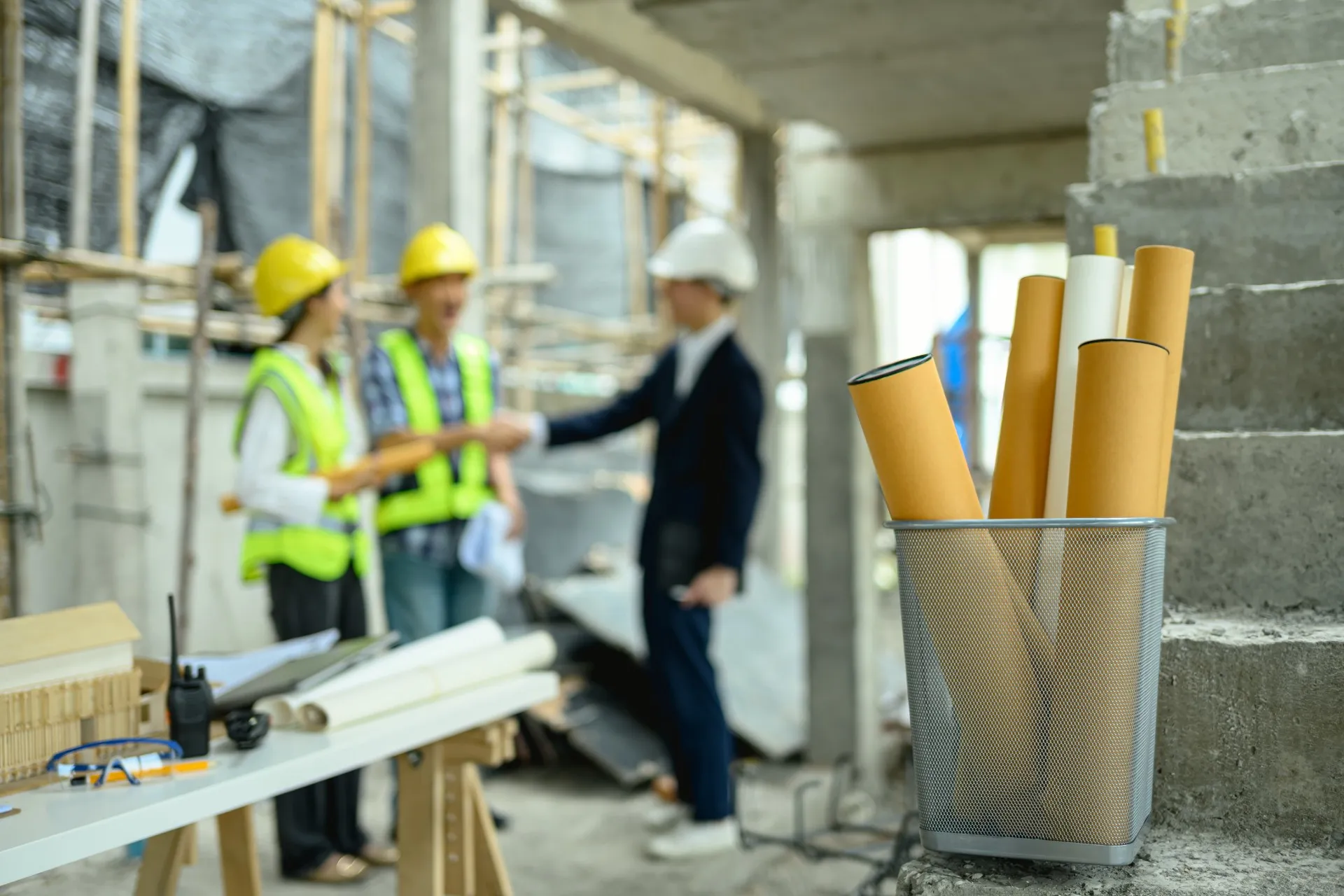 rolled-architectural-blueprints-at-a-construction-2026-01-06-09-47-36-utc-697c86bbb85bd